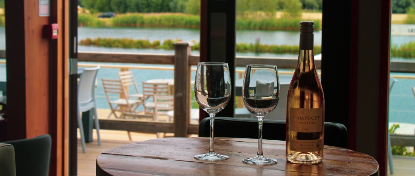 Corner 5 Restaurant's contemporary lakeside dining room with panoramic windows over the water at Box End Park, Bedford